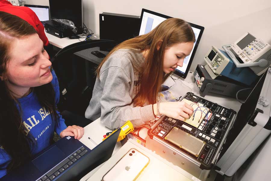 Two female students work together in class