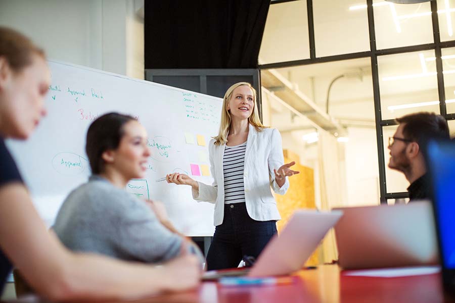 businesswoman in blazer jacket giving presentation