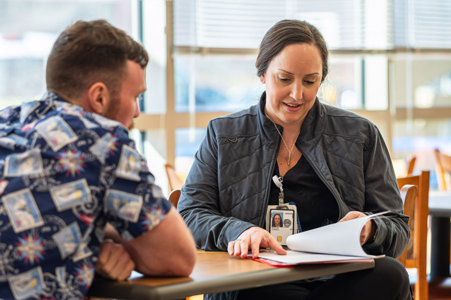 UW-Green Bay graduate at work talking with patient