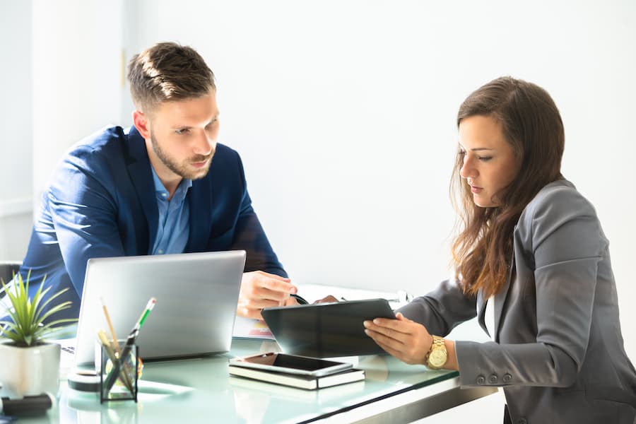 Female accountant works with a client at desk