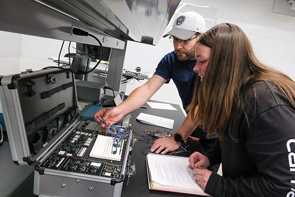 Electrical Engineering students use a trainer board to connect inputs and outputs of a logic circuit during Digital Logic Design Lab inside the Instructional Science's Electrical Engineering Lab at UW-Green Bay