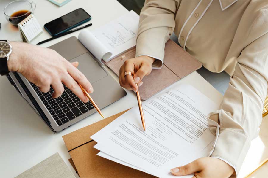 Two people reviewing printed data.