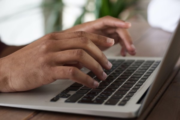 hands typing on keyboard