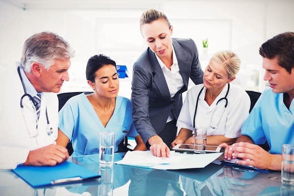 Nurse administrator goes over documents with colleagues