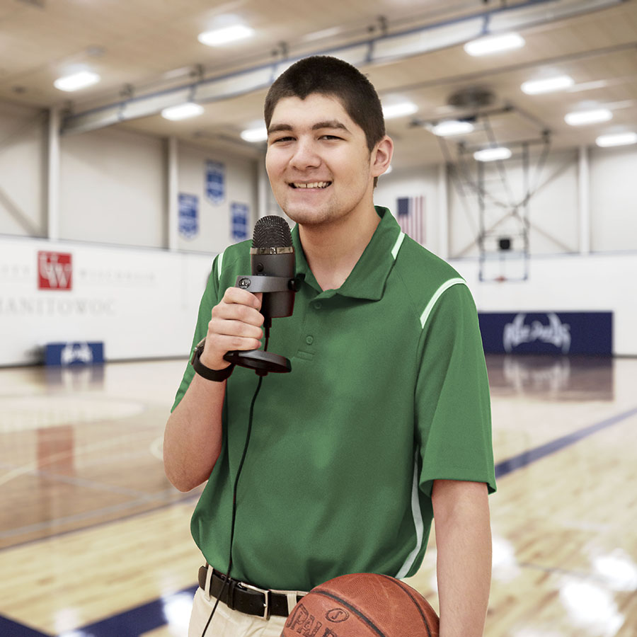 Jordon Lawrenz, holidng sports anouncer microphone in the Manitowoc gym
