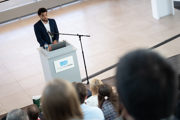 Student presenting in Solving NEW Challenges Business Pitch Competition at Titletown Tech