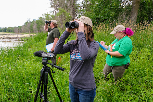 From left to right, Josh Dietzler, Haley Spargur and Brenna Nicholson from the Cofrin Center for Biodiversity conduct bird and frog surveys during the biodiversity research for the Great Lakes Coastal Wetland Monitoring Program (CWMP) at the Point au Sable coastal wetland on the east shore of the Bay of Green Bay on July 12, 2022.