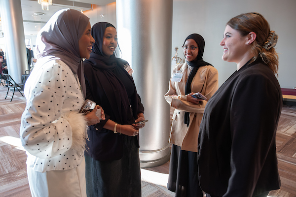 Group of students talking at business event