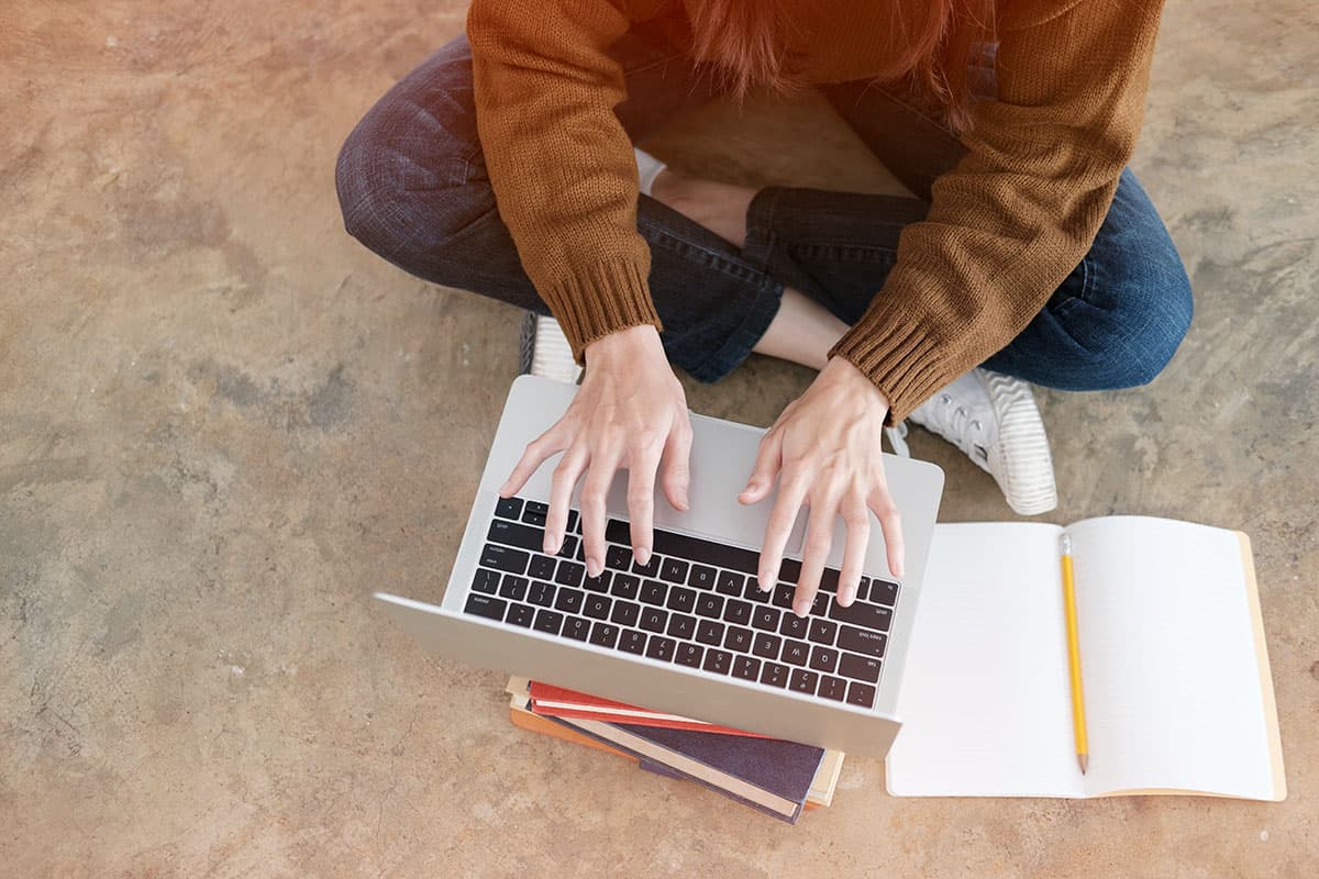 woman sitting with laptop computer