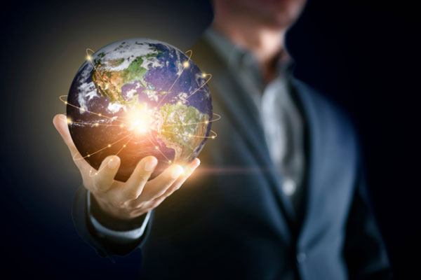 Man in suit holding digital rendering of globe