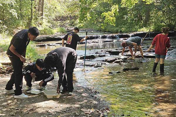 High school students collecting and testing water samples in the Lower Fox River Watershed Monitoring program