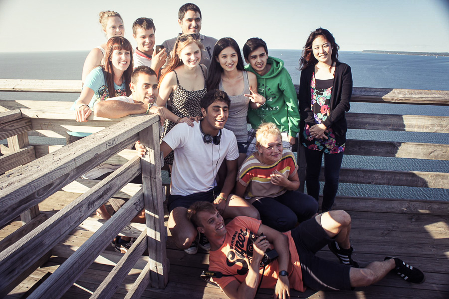 A group of international students pose for a photo at the top of a lookout tower