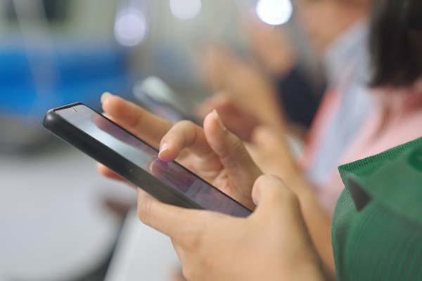close up of hands using a smartphone