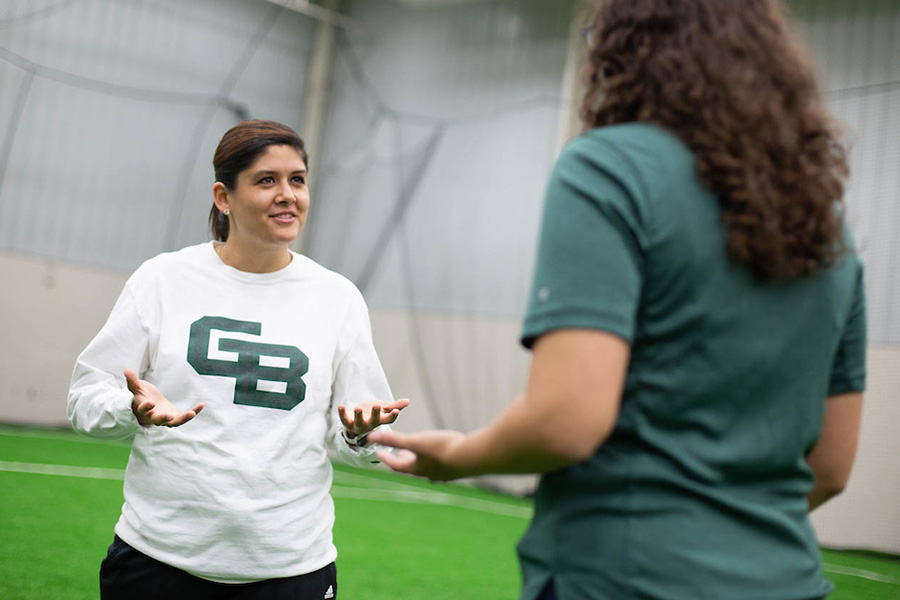 Two women having a discussion in turf room