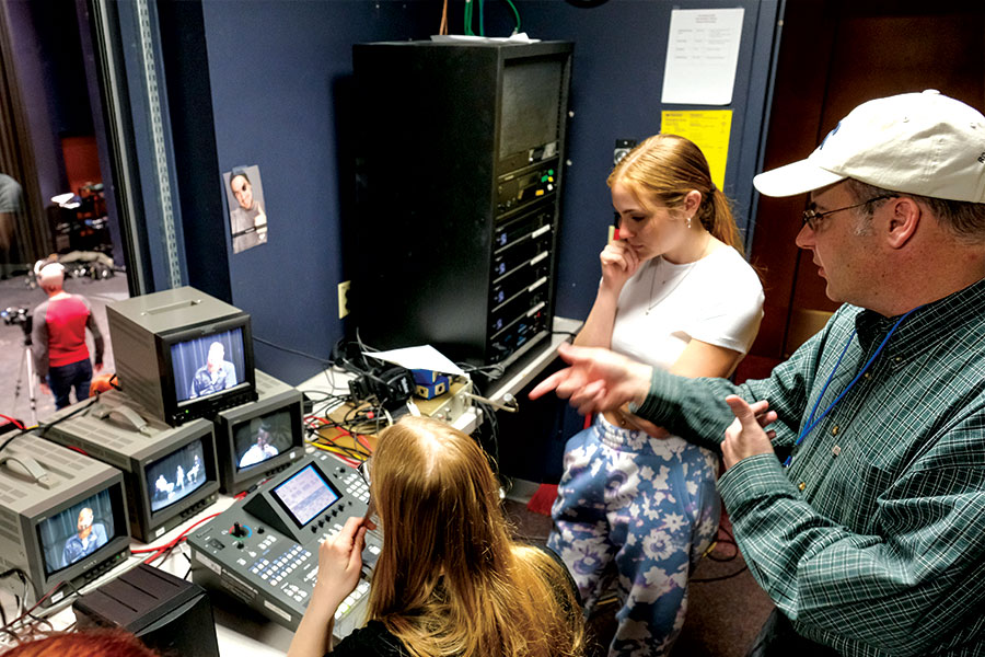 Students behind the scenes using CCTVs and a soundboard.
