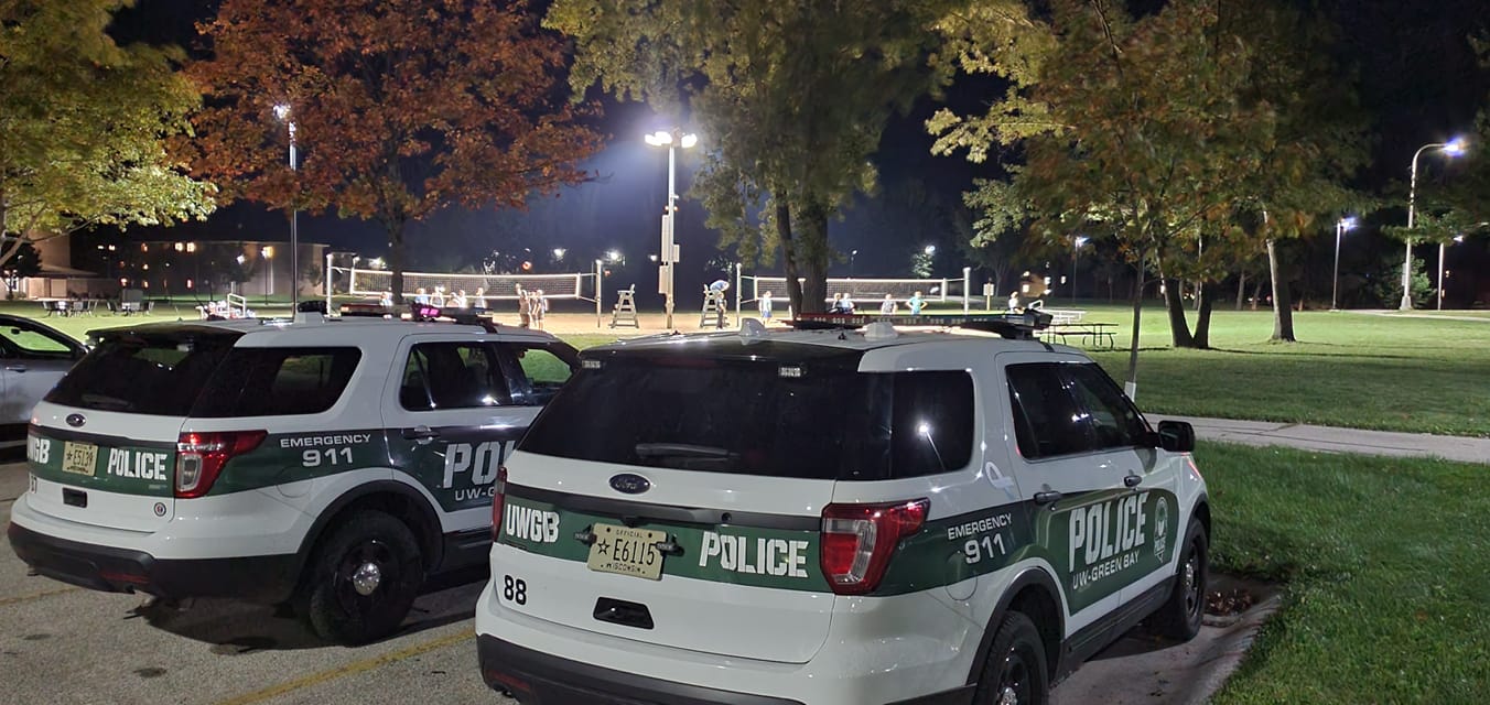 Squad cars by a volleyball match