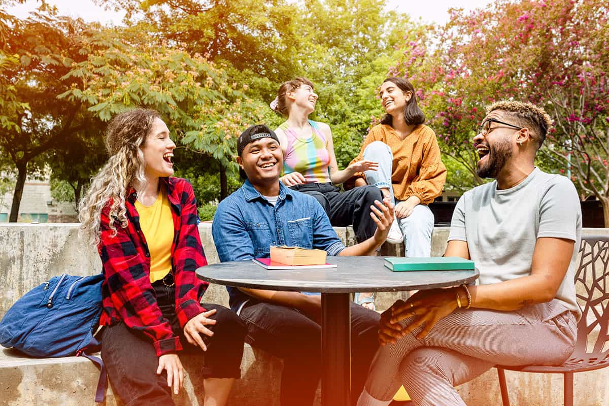 students sitting at table outside during lunch