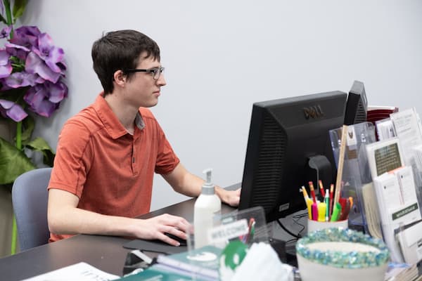 Student employee works at desk