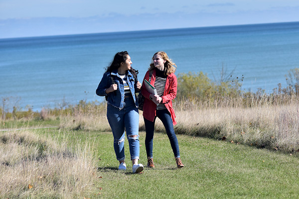 Students walking along lakeshore