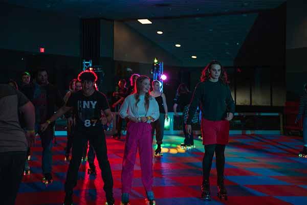 Students participate in glow in the dark roller blading at a GB Nites event